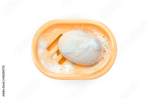Fotografie Soap in soap dish isolated on white background. Foam