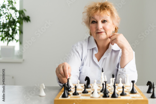 close-up view of elderly woman playing chess