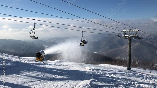 Snow cannon in the process of snowmaking on the ski slope