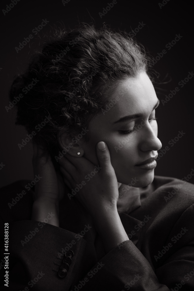 Black and White Portrait of Beautiful young curly woman.