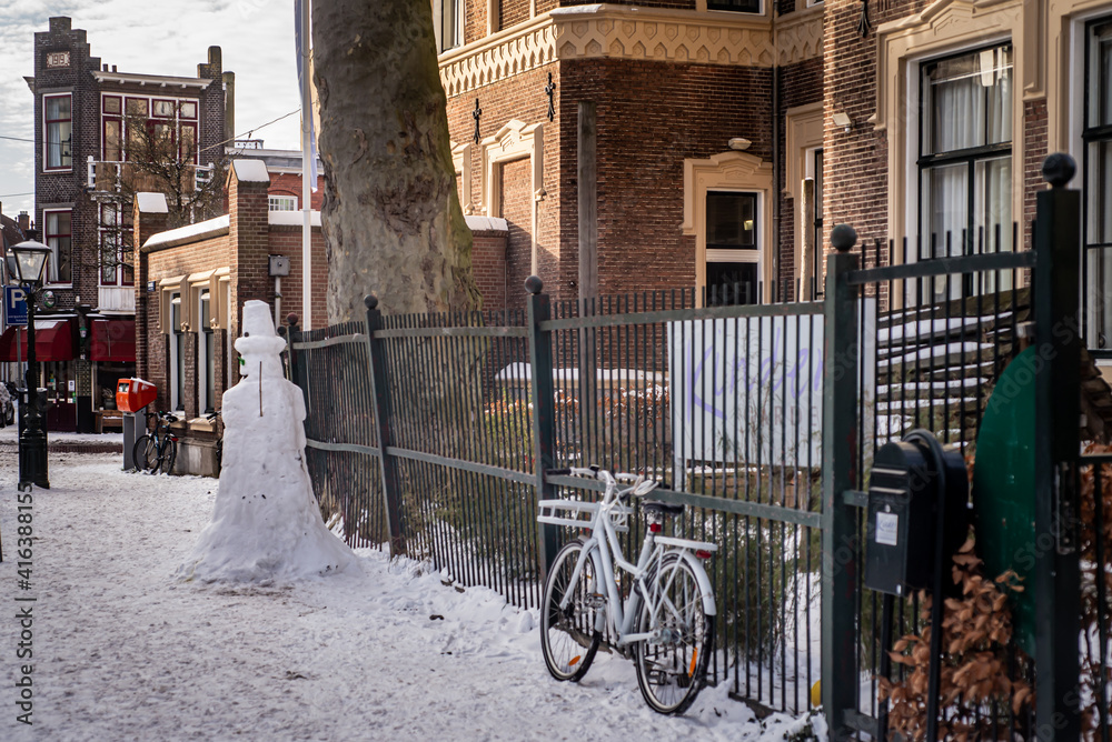 Jolly snowman on the street during the winter storm Darcy, Leiden, Netherlands