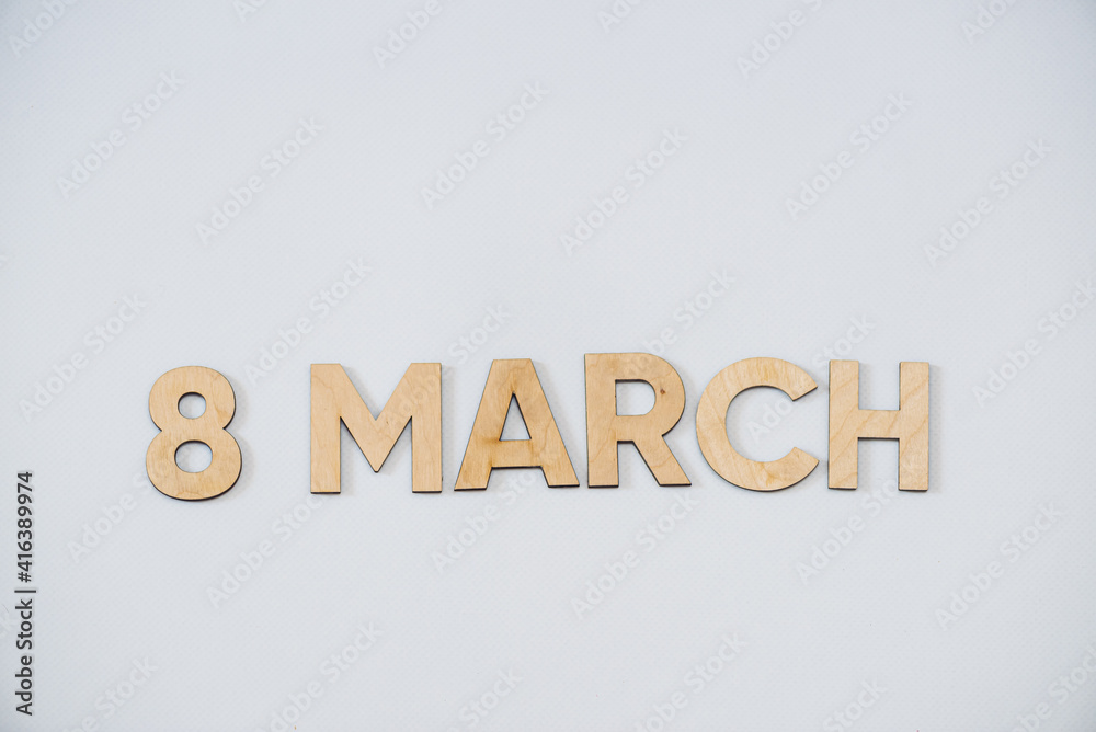 Wooden letters on a background. Congratulations with women day Wooden letters on a background. Congratulations with women day