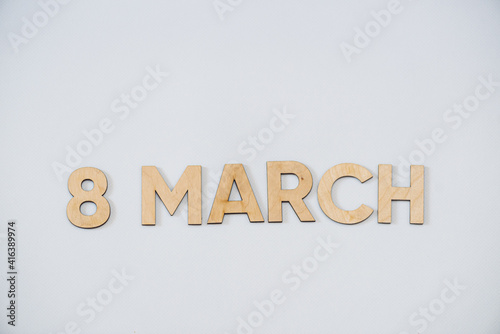 Wooden letters on a background. Congratulations with women day