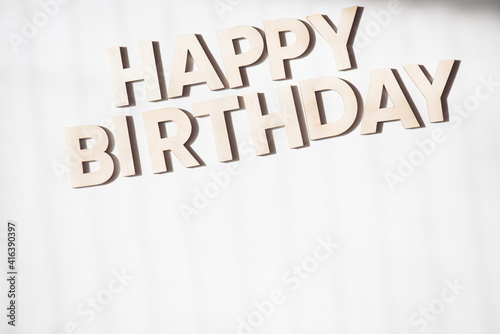Wooden letters on a background. Congratulations with birth day