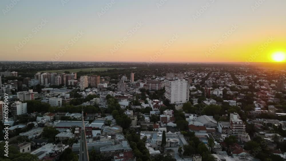 Aerial jib up shot rising behind cathedral spire and revealing the sunset at the neighborhood Aerial jib up shot rising behind cathedral spire and revealing the sunset at the neighborhood