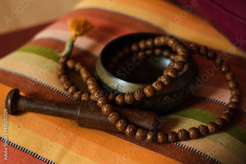 Tibetan bowl with a mala on a nice colorful cushion