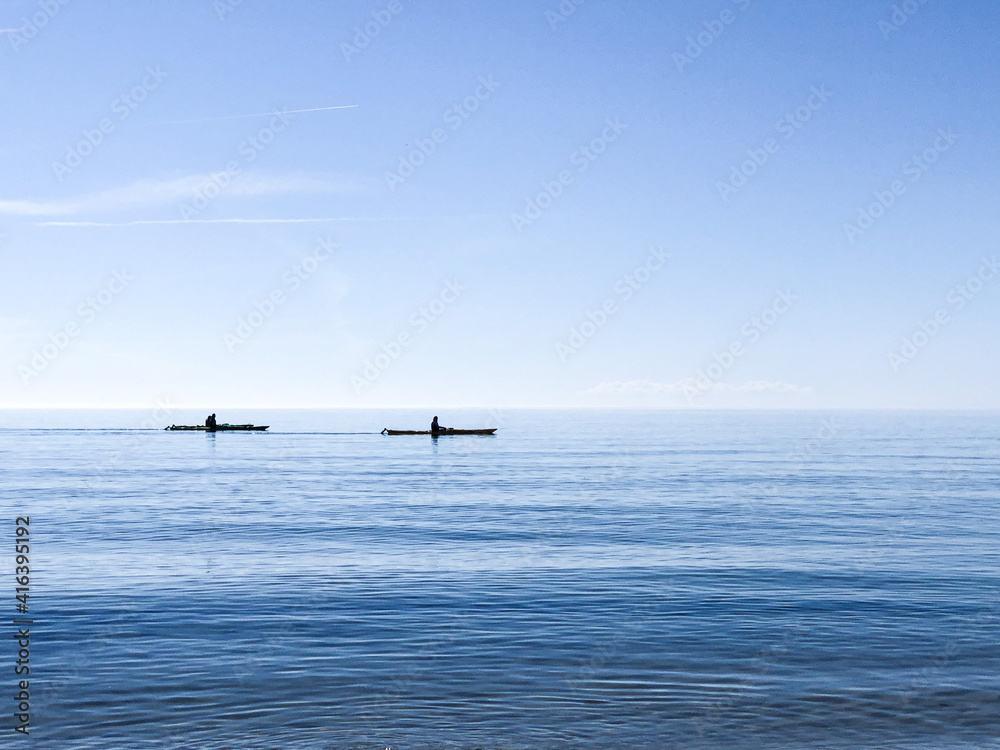 Photo of silhouettes kayaking