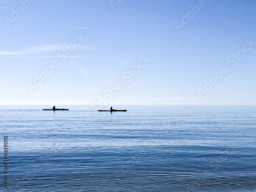 Photo of silhouettes kayaking