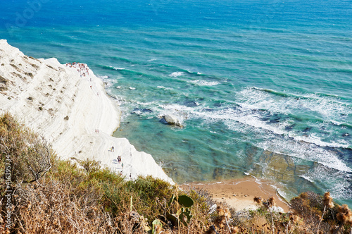 Tourists stroll and sunbathe at the 