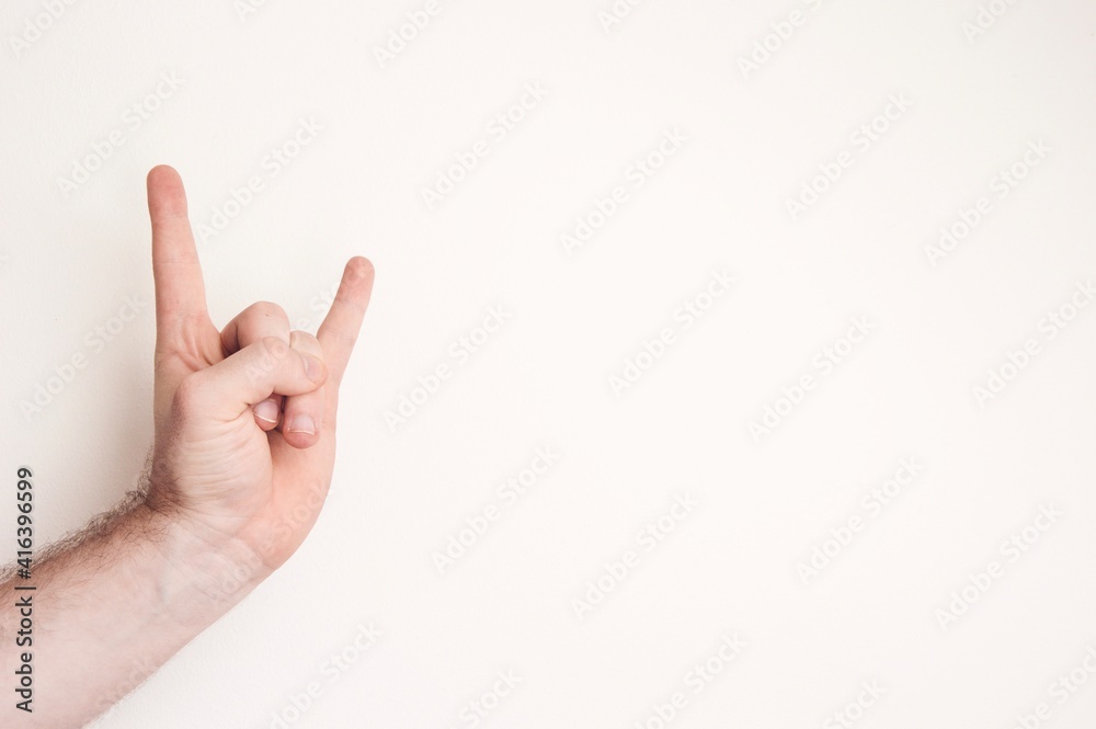 Photo of a person making a hand sign Photo of a person making a hand sign