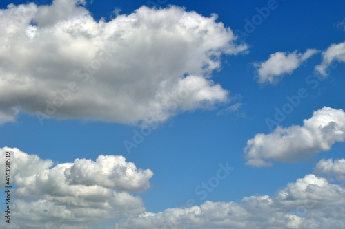 Fluffy White Clouds against Blue Sky 