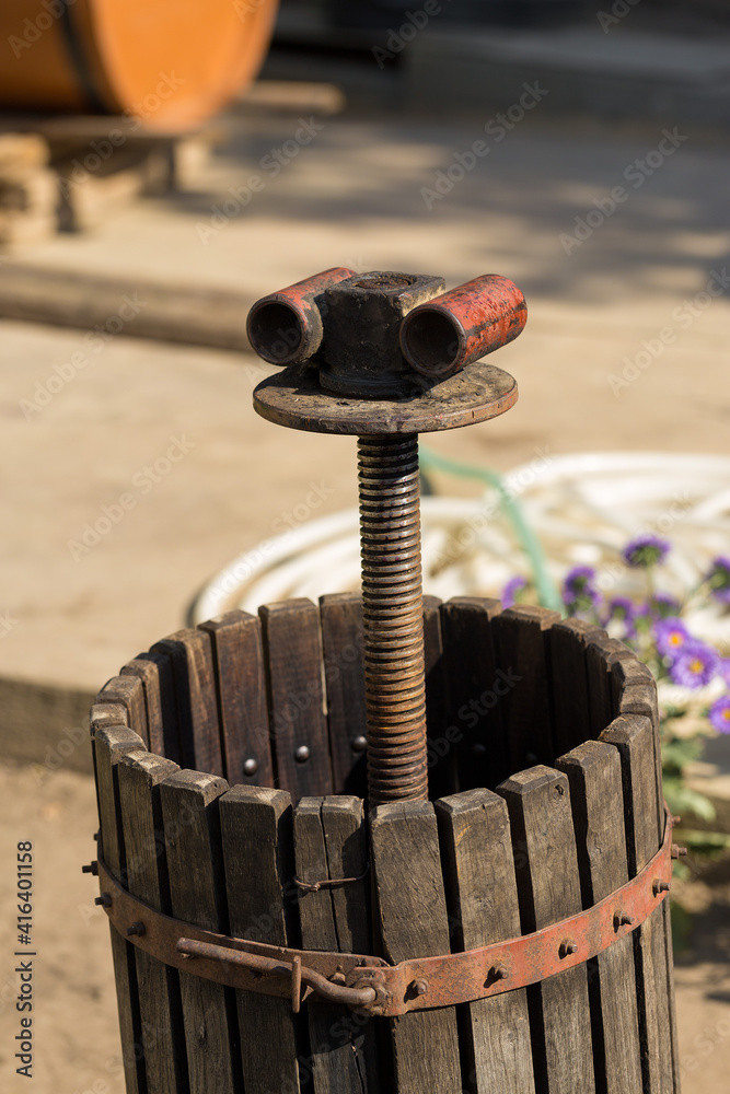 Winepress with red must and helical screw. Production of traditional Italian wines, crushing of grapes. Winepress with red must and helical screw. Production of traditional Italian wines, crushing of grapes.