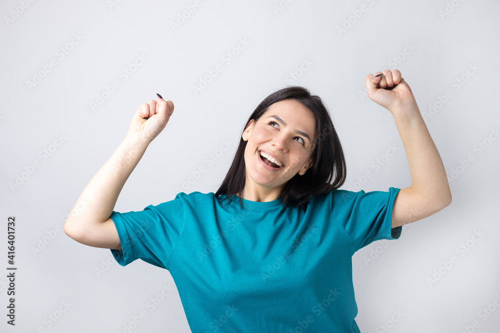 Close up portrait of attractive shouting in winning smiling with raised fists young she her girl wearing jeans shirt clothes isolated on grey background Close up portrait of attractive shouting in winning smiling with raised fists young she her girl wearing jeans shirt clothes isolated on grey background