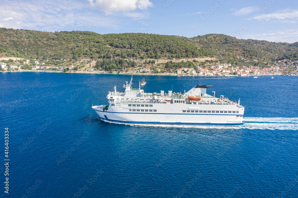 Aerial drone shot of ferry cruise leaving port in Adriatic sea in croatia summer