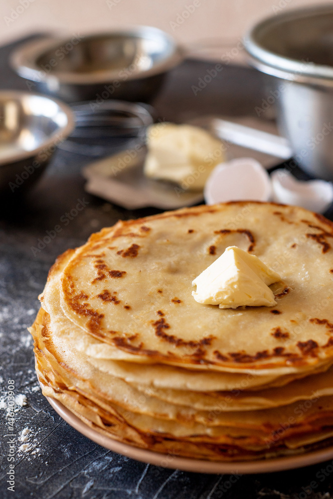 a stack of pancakes and products for making pancakes - Russian traditional cuisine: milk, eggs, flour, butter. a stack of pancakes and products for making pancakes - Russian traditional cuisine: milk, eggs, flour, butter.