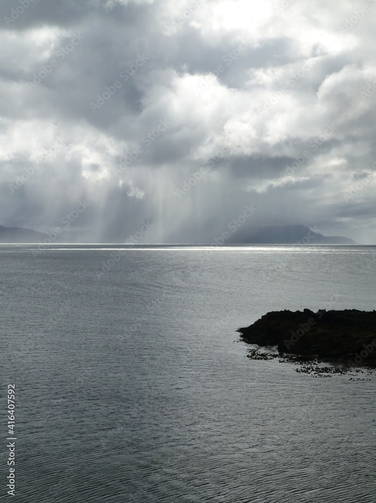 Heavy rain showers falling over Rum, as seen from the Rubha an Donain on Skye