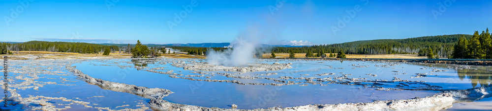 Panorama of circular tiered thermal pools reflecting the clear blue sky with a steaming center building pressure Panorama of circular tiered thermal pools reflecting the clear blue sky with a steaming center building pressure