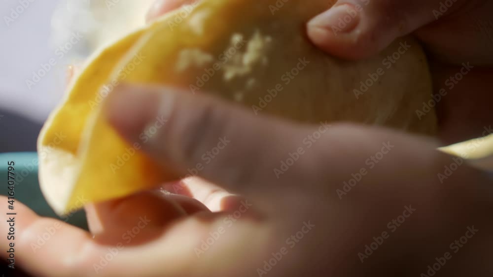 Hands adding mashed potatoes to a taco with soft tortilla