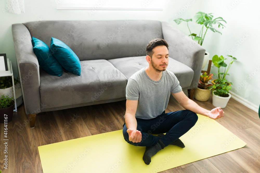 Hispanic man with his eyes closed and doing a meditation