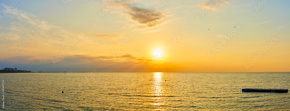 Fototapeta premium Amazing Sunset on the Sea. Adriatic sea, beautiful sunset, waves and landscape. Lignano Sabbiadoro, Italy.