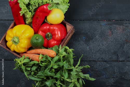 Pepper  lettuce  carrot  lemon  lime and mint in wooden box