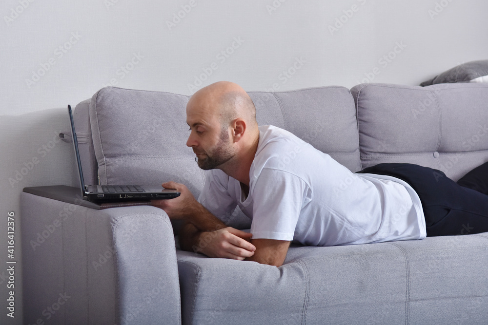 Young man in livingroom using laptop