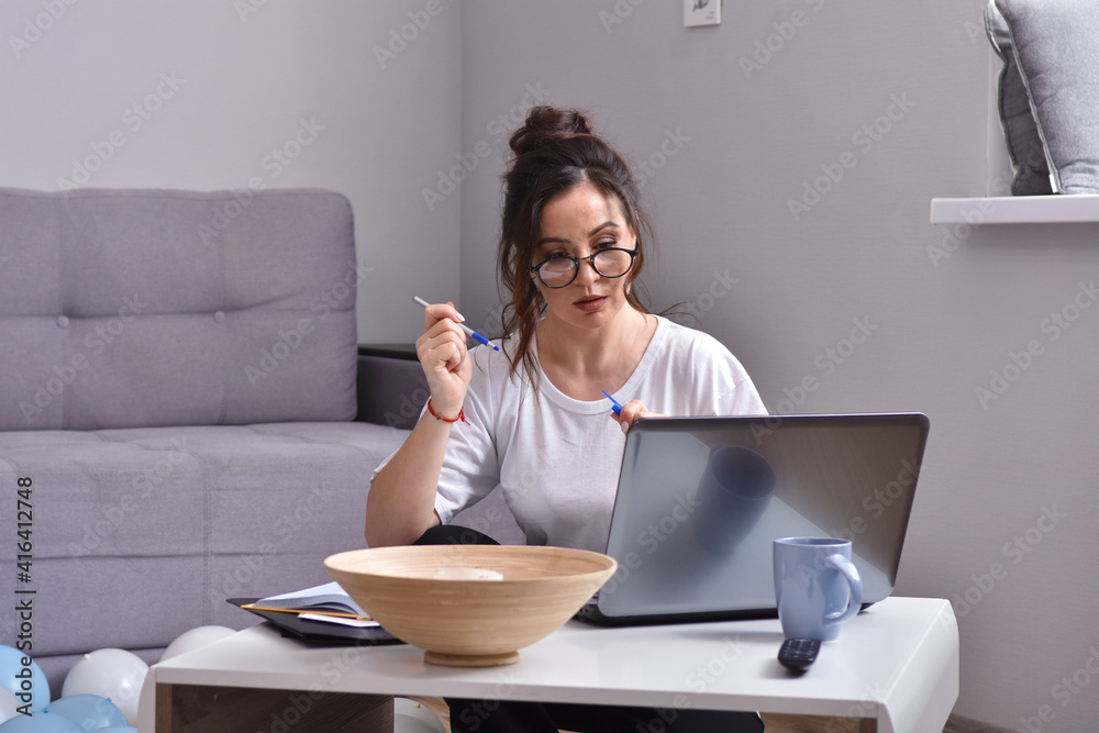 Beauiful young woman working at home