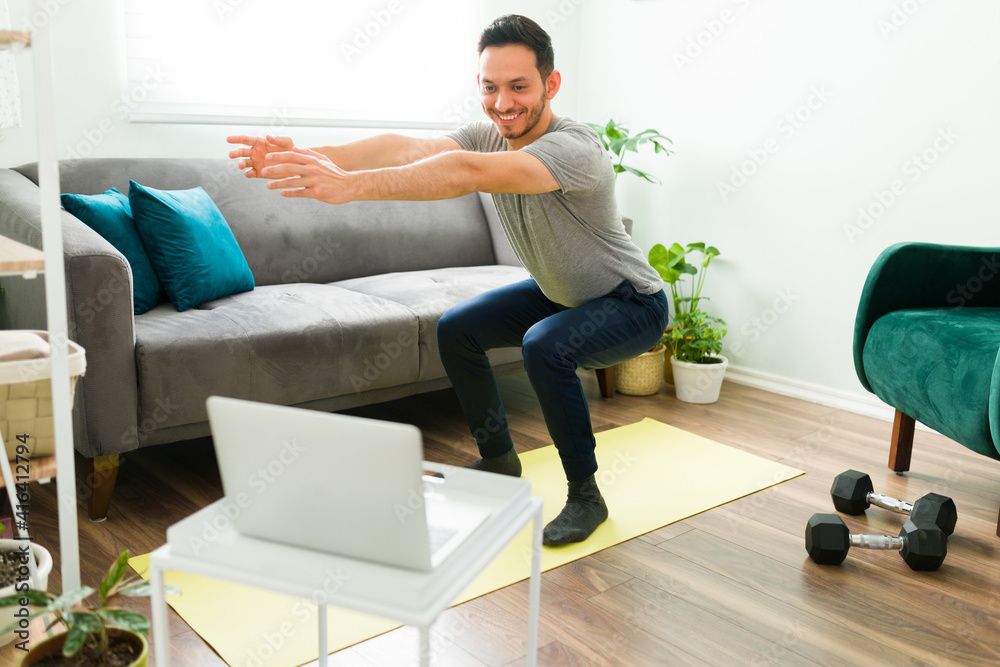 Young man feeling excited to do a home workout Young man feeling excited to do a home workout