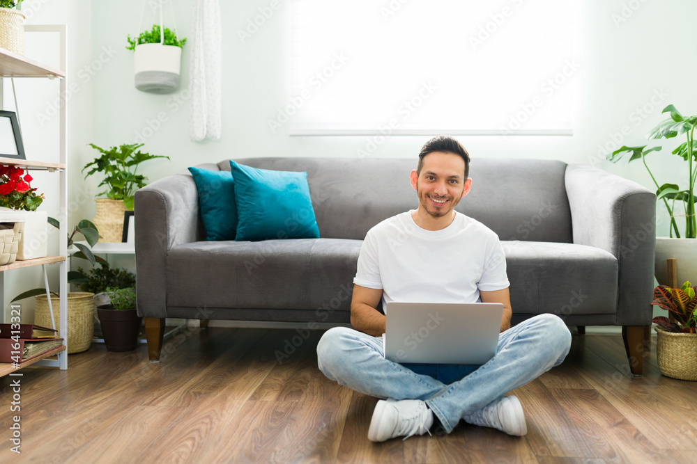Happy attractive man chatting online with friends on his laptop Happy attractive man chatting online with friends on his laptop