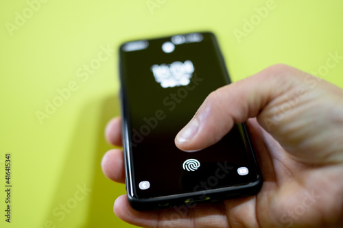 Young man Scanning Fingerprint For Security unlock On Smartphone. Biometric Security