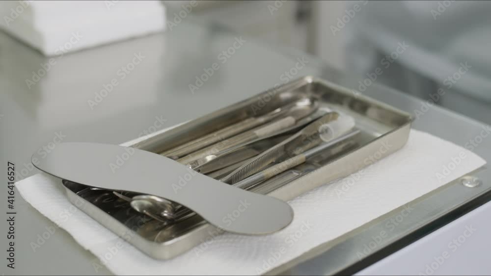 Doctor's metal instruments lie on the table. Dentistry
Doctor's metal instruments lie on the table. Dentistry