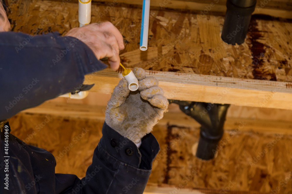 Gluing parts of a pvc water pipe using cement glue assembly