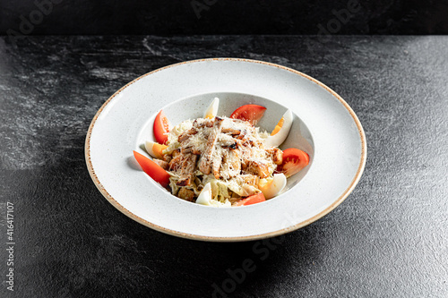 Fresh salad with chicken breast, arugula, black olives,red pepper, lettuce, fresh sald leaves and tomato photo