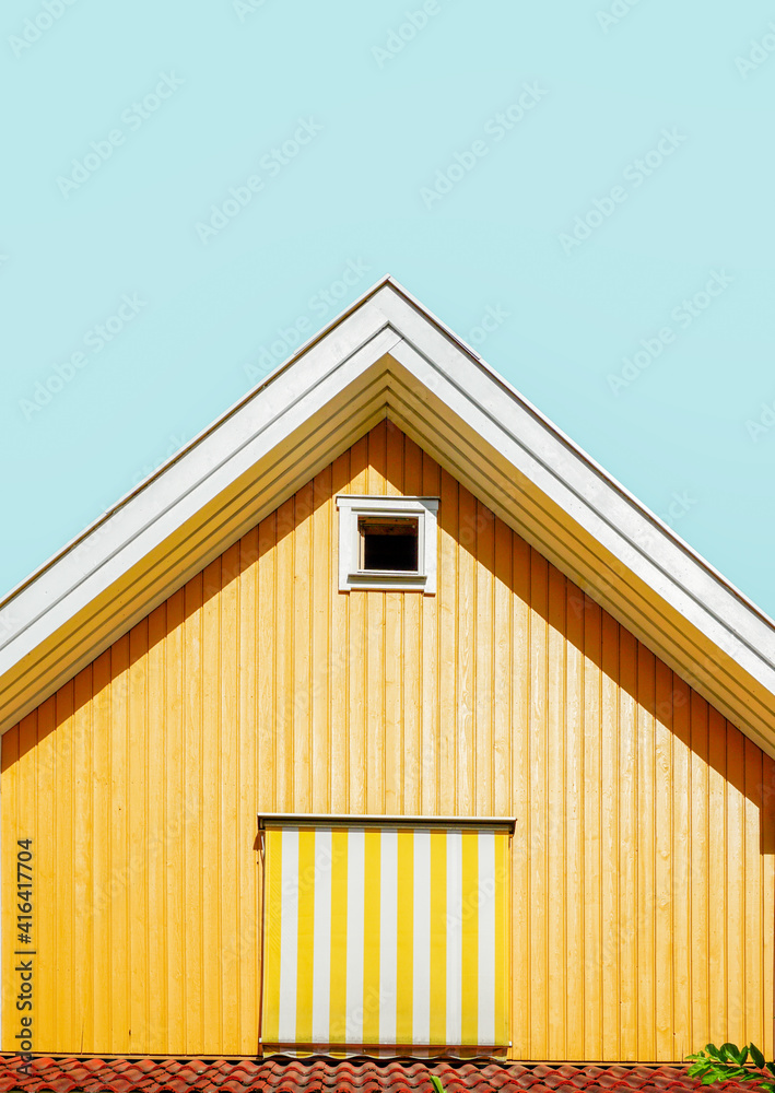 Yellow house with wooden cladding in Oslo, Norway.