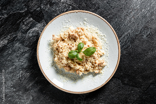 Delicious risotto with chicken stone background photo