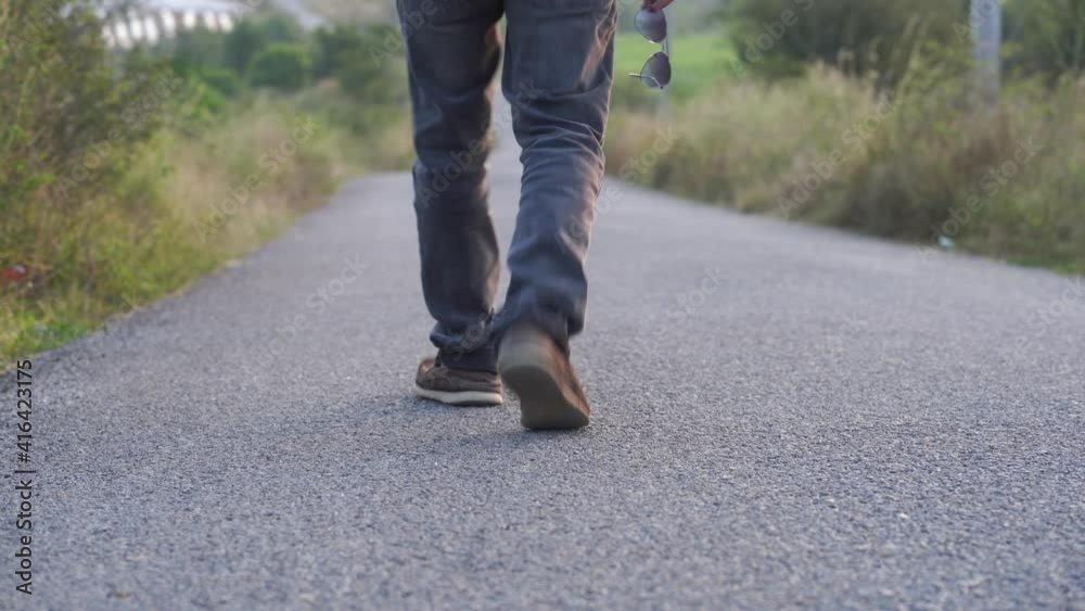 indian Man walking a lonely road indian Man walking a lonely road