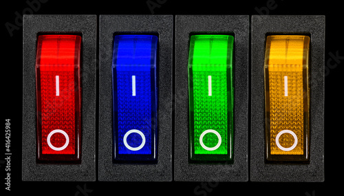 Obraz na płótnie Red, blue, green and yellow power switches at OF position, isolated on black background w salonie
