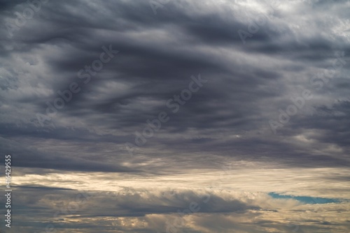 This image shows a dark sunset sky filled with clouds.