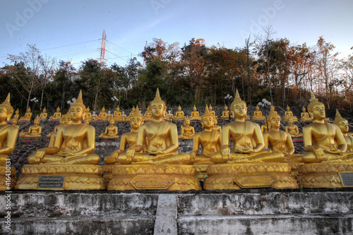 Golden Buddha statues at sunset in Pakse Laos