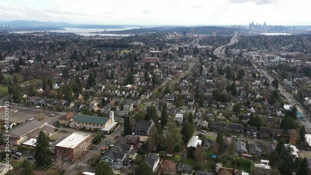 Cinematic aerial drone dolly clip of Maple Leaf, Roosevelt, Ravenna, Green Lake, Meridian, University District, I-5 freeway with Lake Union, Lake Washington and downtown Seattle in the distance