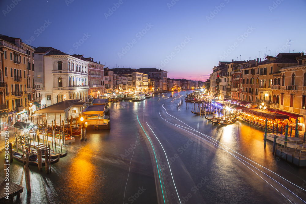 Long exposure with boats on the Grand Canal at night, Venice, Italy