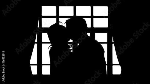 Couple kissing in large window
