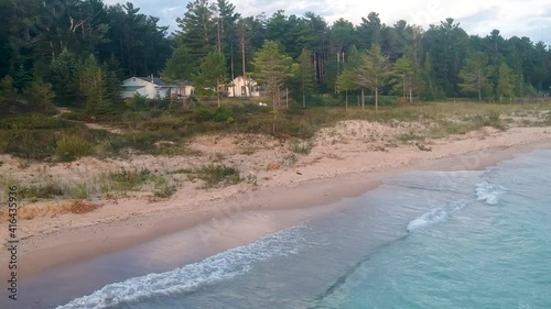 Aerial view of ocean blue waves break on a beach. Sea waves and beautiful sand beach aerial view drone shot. Hoeft State park in Michigan. photo