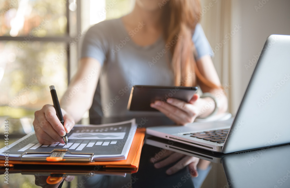 Business documents on the desk with a notebook and business graph graph with office icons in the morning. Business documents on the desk with a notebook and business graph graph with office icons in the morning.