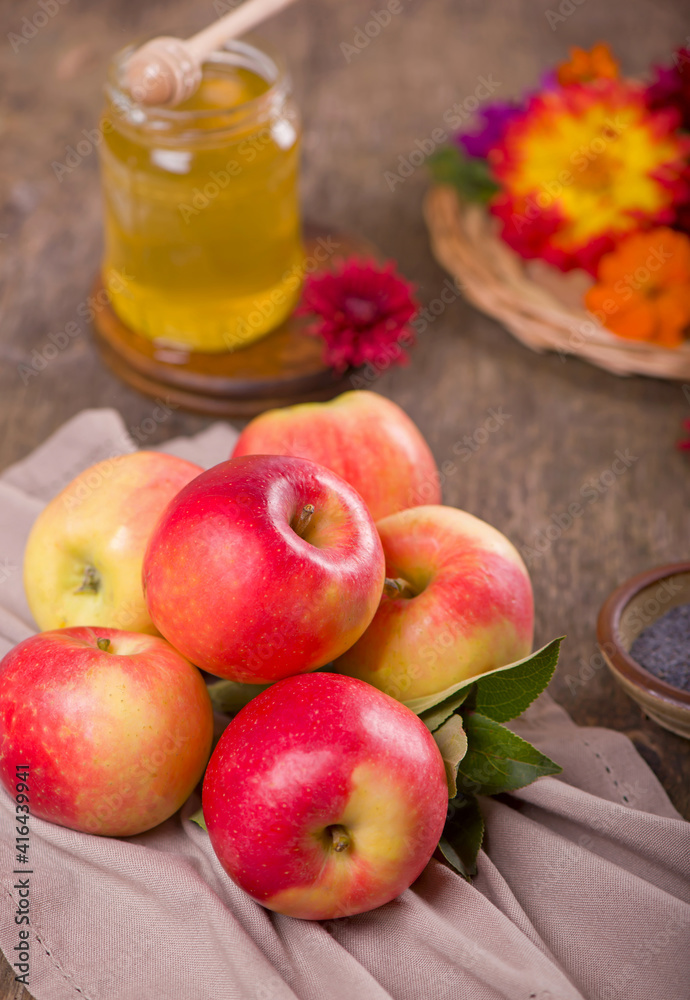 Apple and honey, traditional food of jewish New Year celebration, Rosh Hashana. Selective focus. Copyspace background