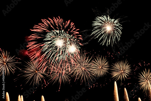 Real fireworks on deep black background sky  beautiful colorful fireworks shiny display at night