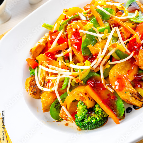 sweet and sour chicken with rice and vegetables photo