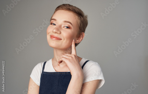 Woman with short hair Makeup on her face gray background