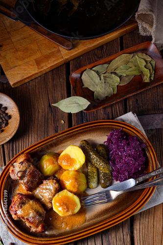 Rustic Snirtjebraten with red cabbage and cucumber photo