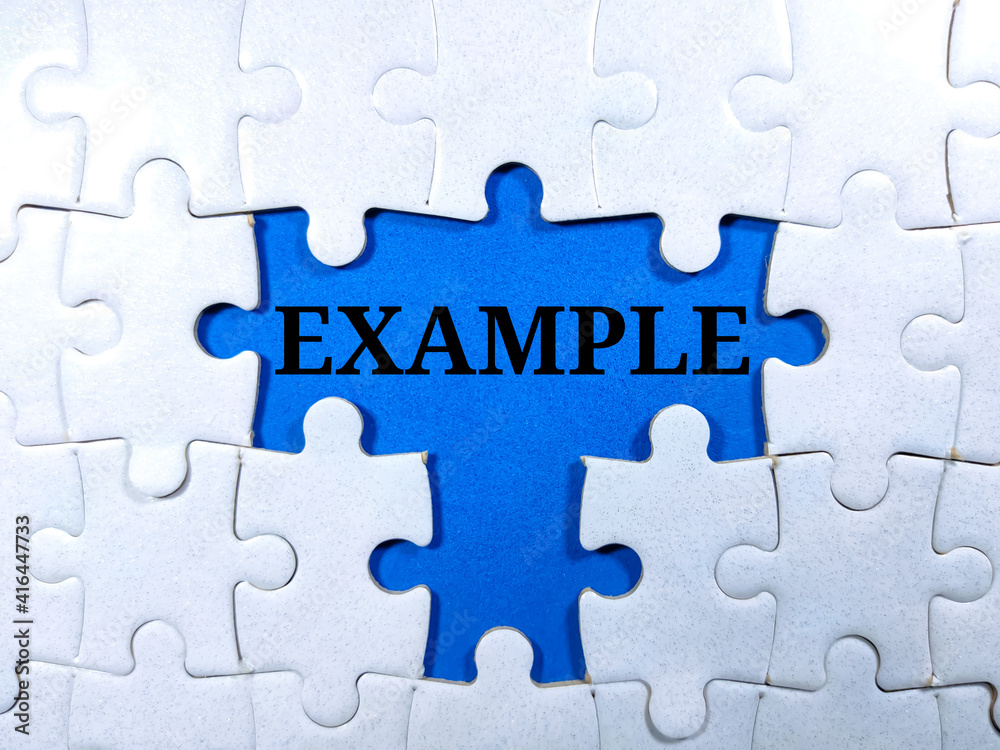 Selective focus.Word EXAMPLE with jigsaw puzzle on blue background.Business concept. Selective focus.Word EXAMPLE with jigsaw puzzle on blue background.Business concept.